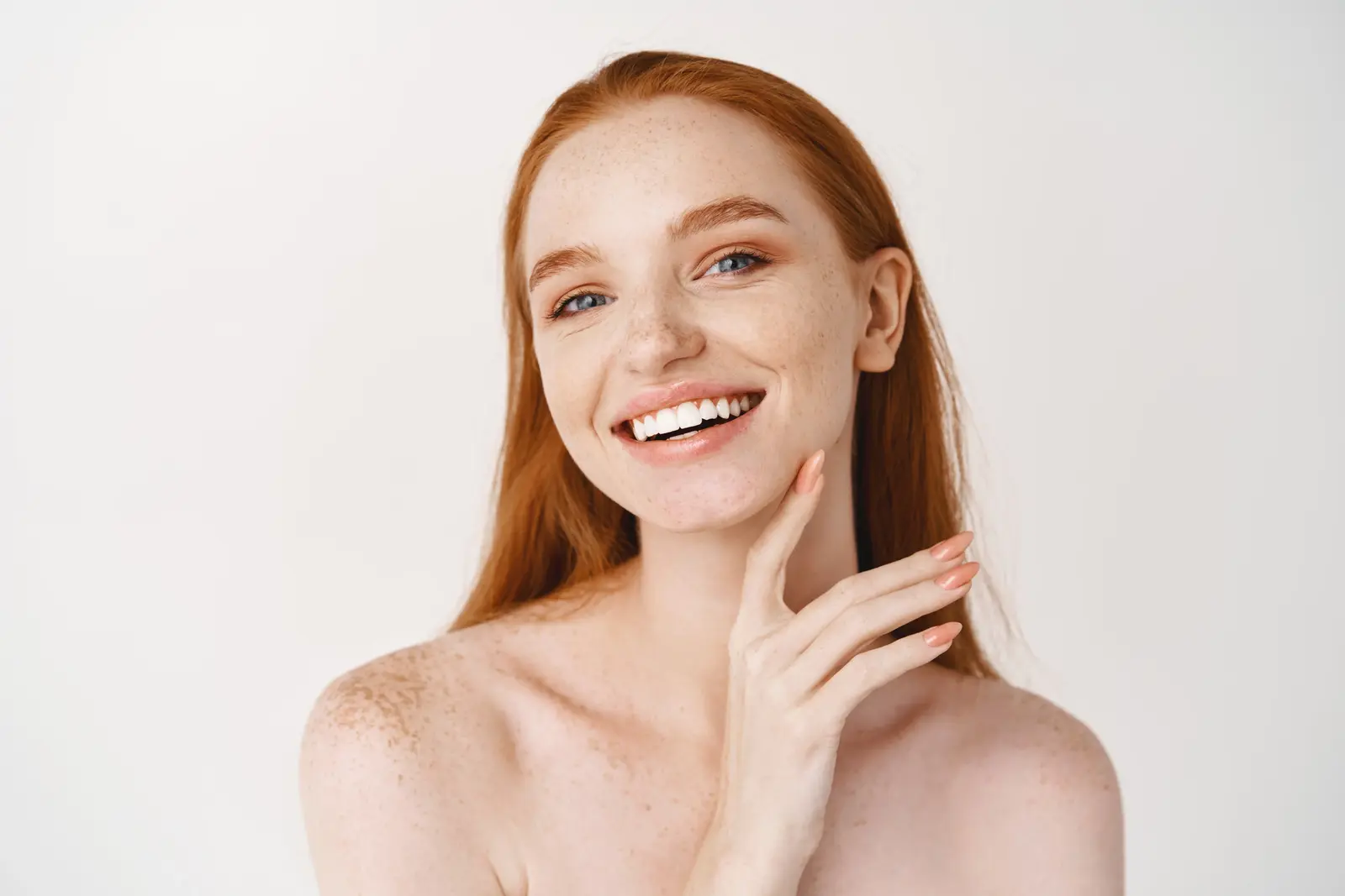 Woman with smooth skin and natural makeup looking at camera